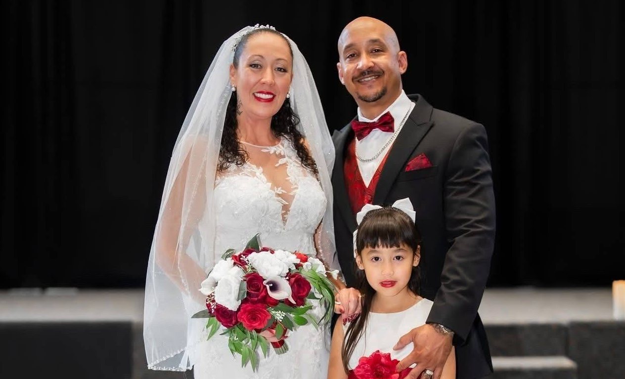 Paul with his wife and daughter on their wedding day